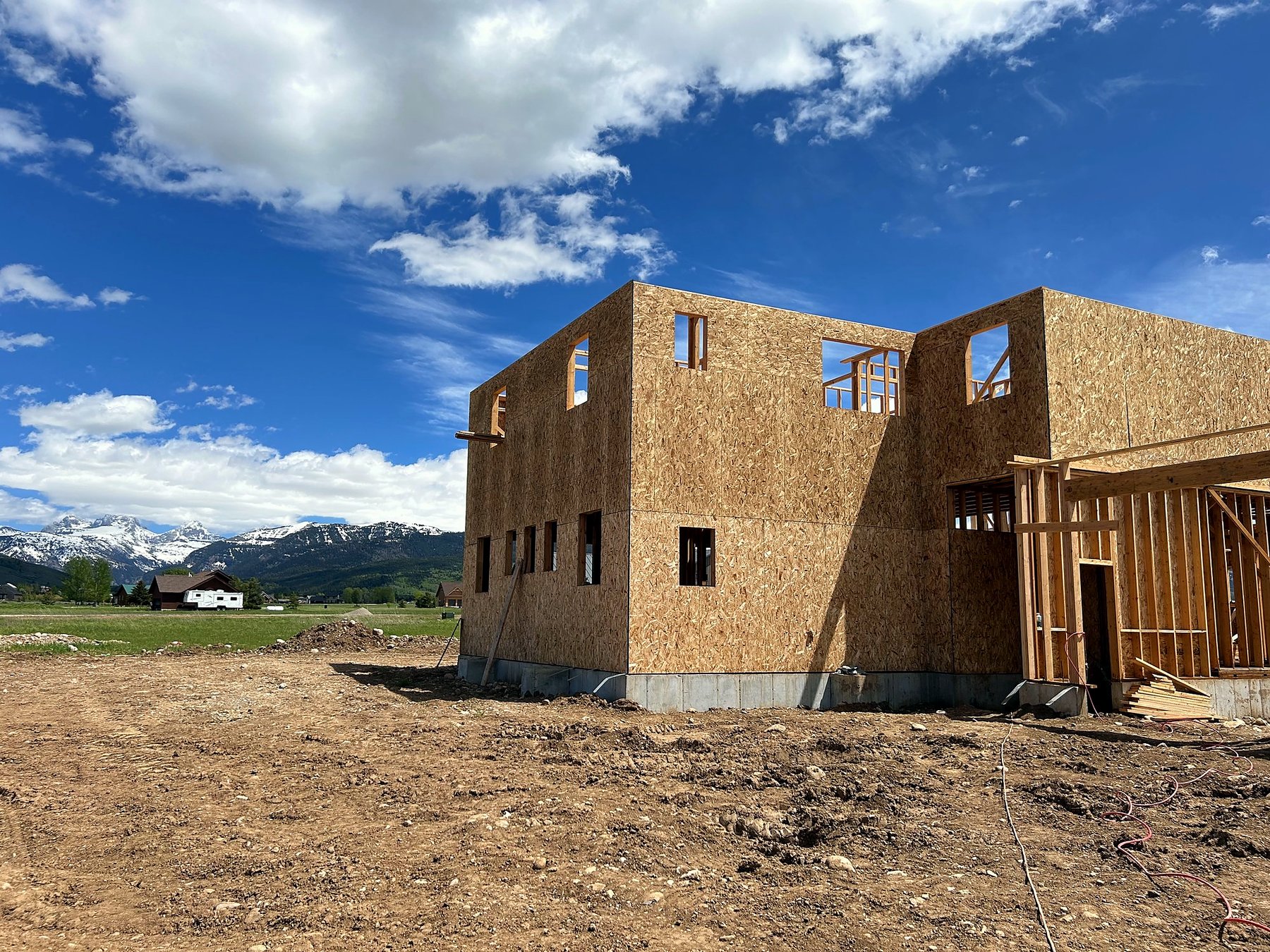 Framing rises against the Tetons — Arbogast custom home build by SwagerBuilds, Driggs Idaho