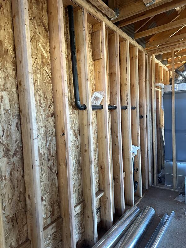 Mechanical rough-in plumbing and ductwork during a SwagerBuilds custom home build