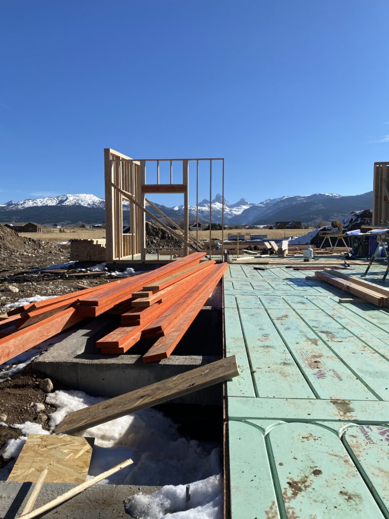 construction on new custom home with Grand Teton mountains in the background